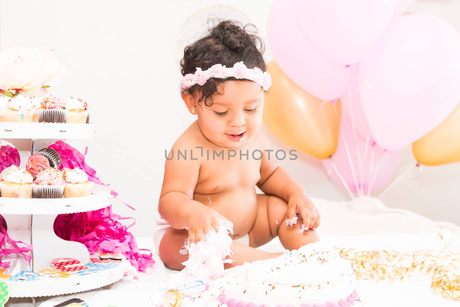 Young Baby Girl Celebrating Her First Birthday With Cake