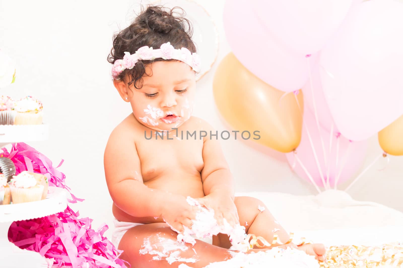 Young Baby Girl Celebrating Her First Birthday With Cake