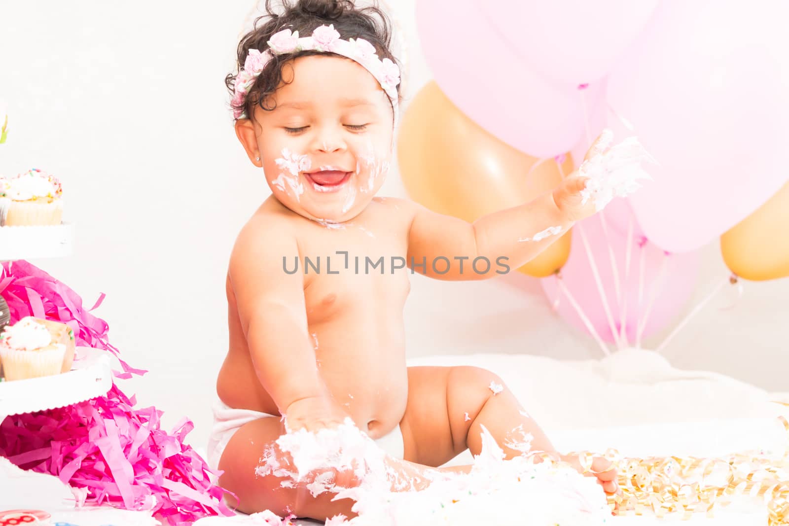 Young Baby Girl Celebrating Her First Birthday With Cake