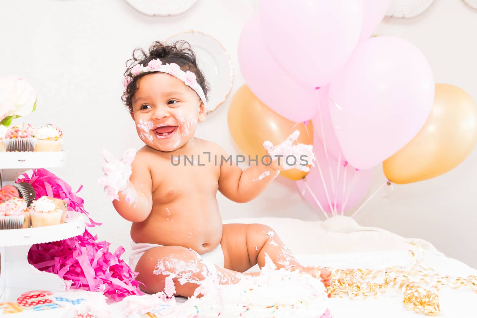 Young Baby Girl Celebrating Her First Birthday With Cake