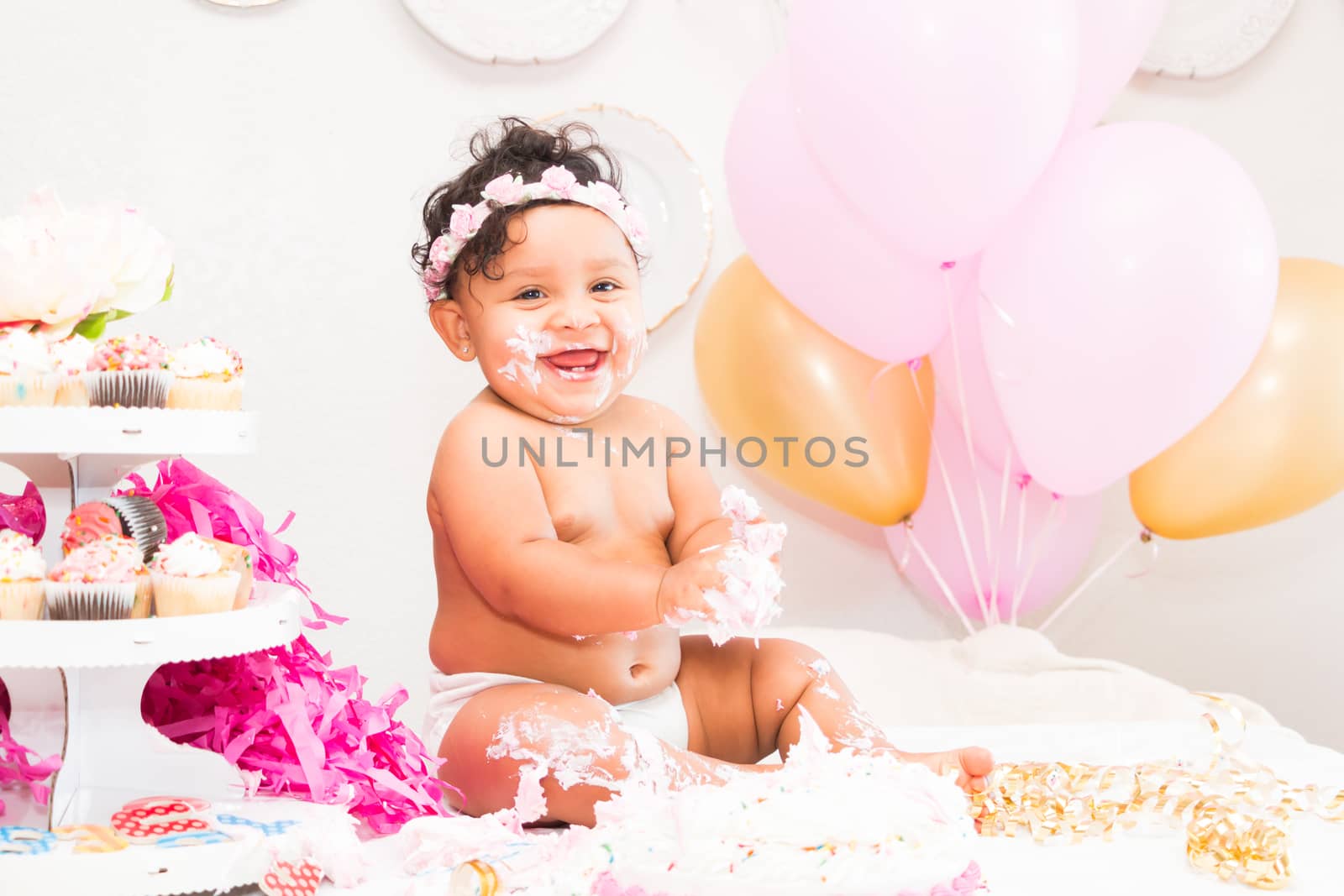 Young Baby Girl Celebrating Her First Birthday With Cake