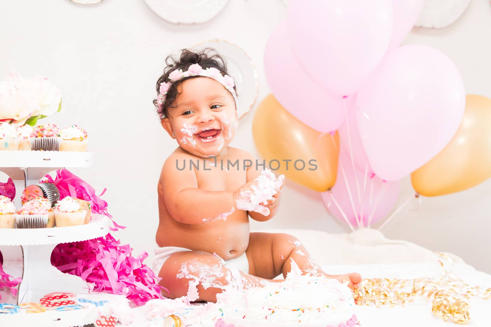 Young Baby Girl Celebrating Her First Birthday With Cake