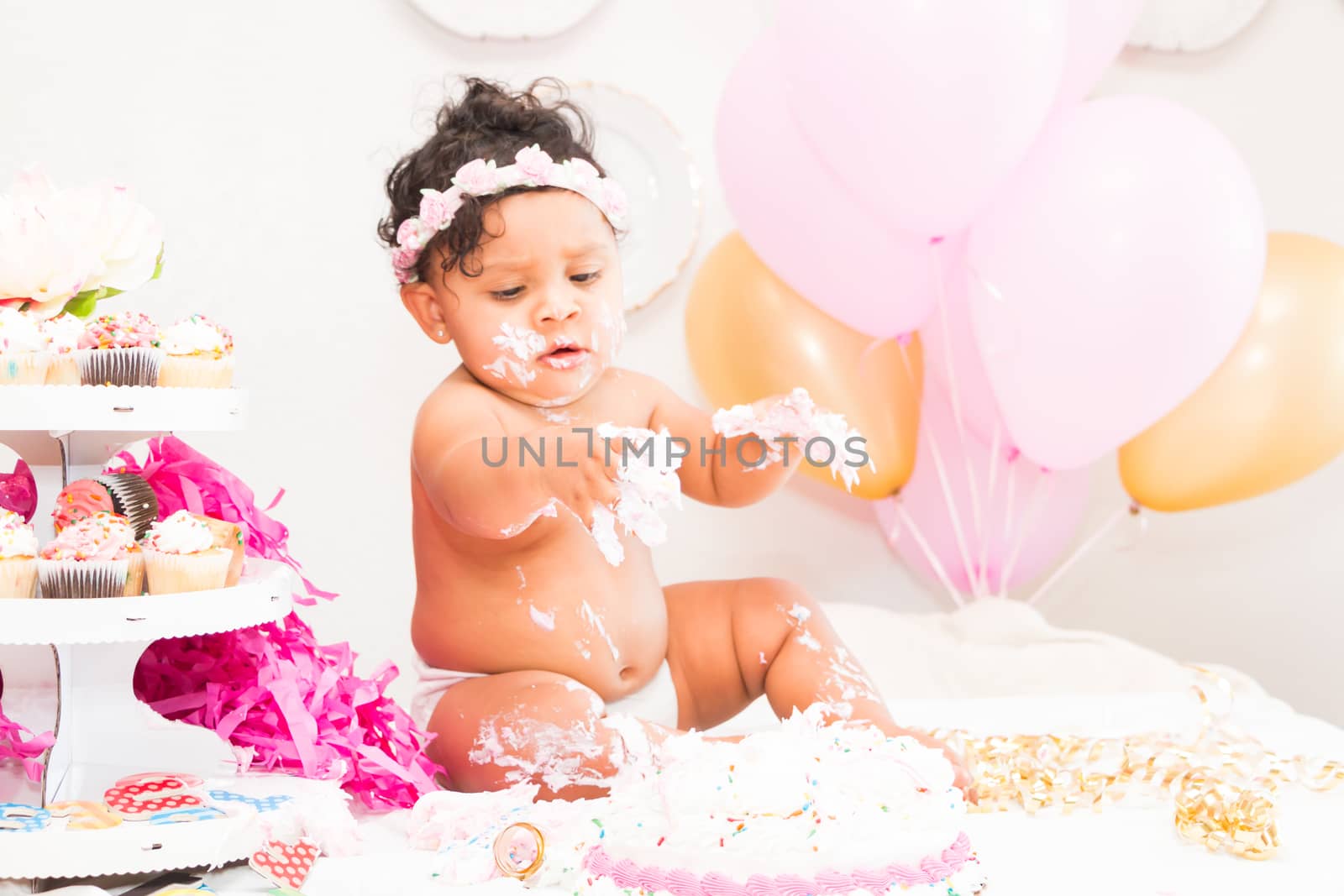 Young Baby Girl Celebrating Her First Birthday With Cake