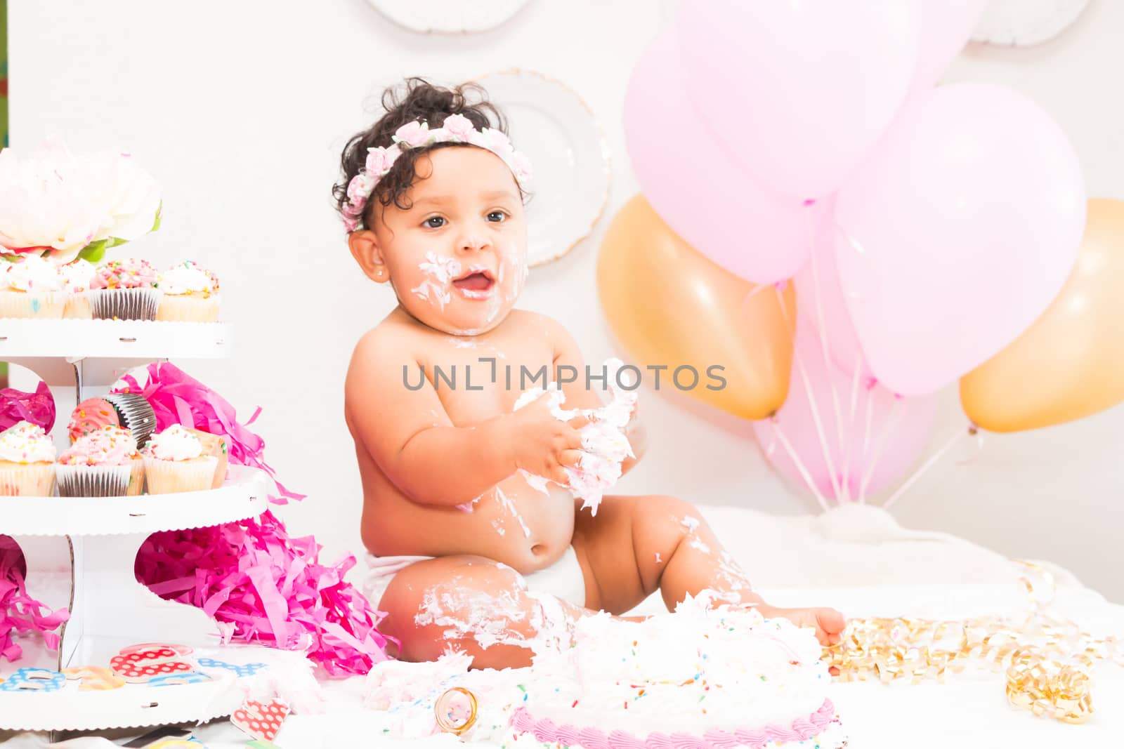 Young Baby Girl Celebrating Her First Birthday With Cake