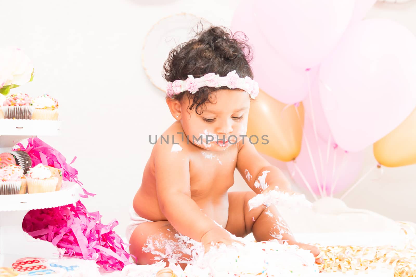 Young Baby Girl Celebrating Her First Birthday With Cake