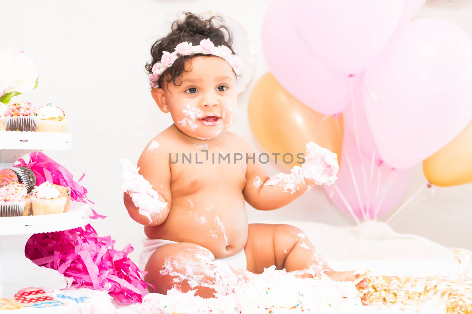 Young Baby Girl Celebrating Her First Birthday With Cake