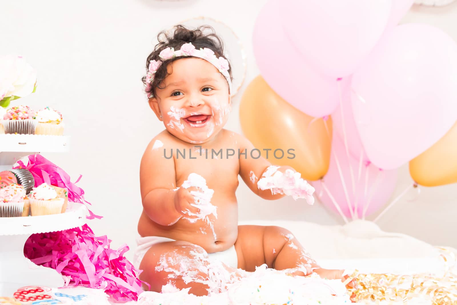 Young Baby Girl Celebrating Her First Birthday With Cake