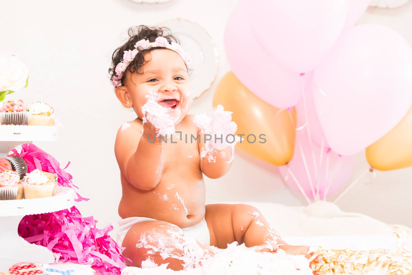 Young Baby Girl Celebrating Her First Birthday With Cake