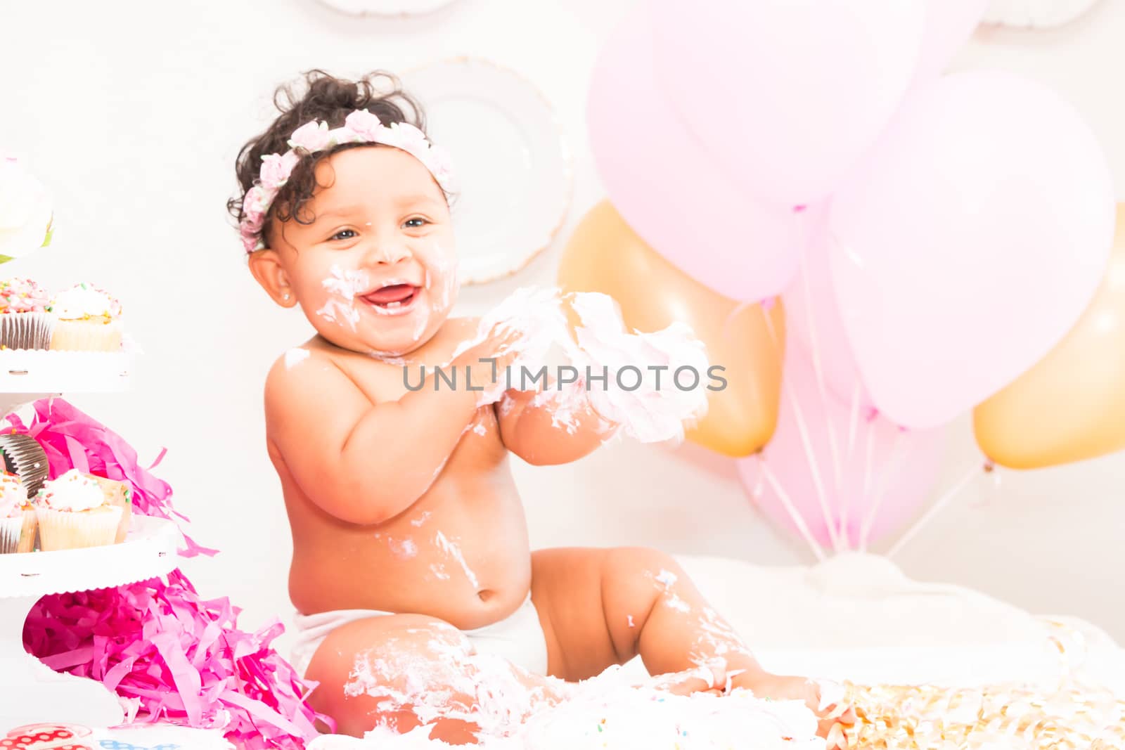 Young Baby Girl Celebrating Her First Birthday With Cake