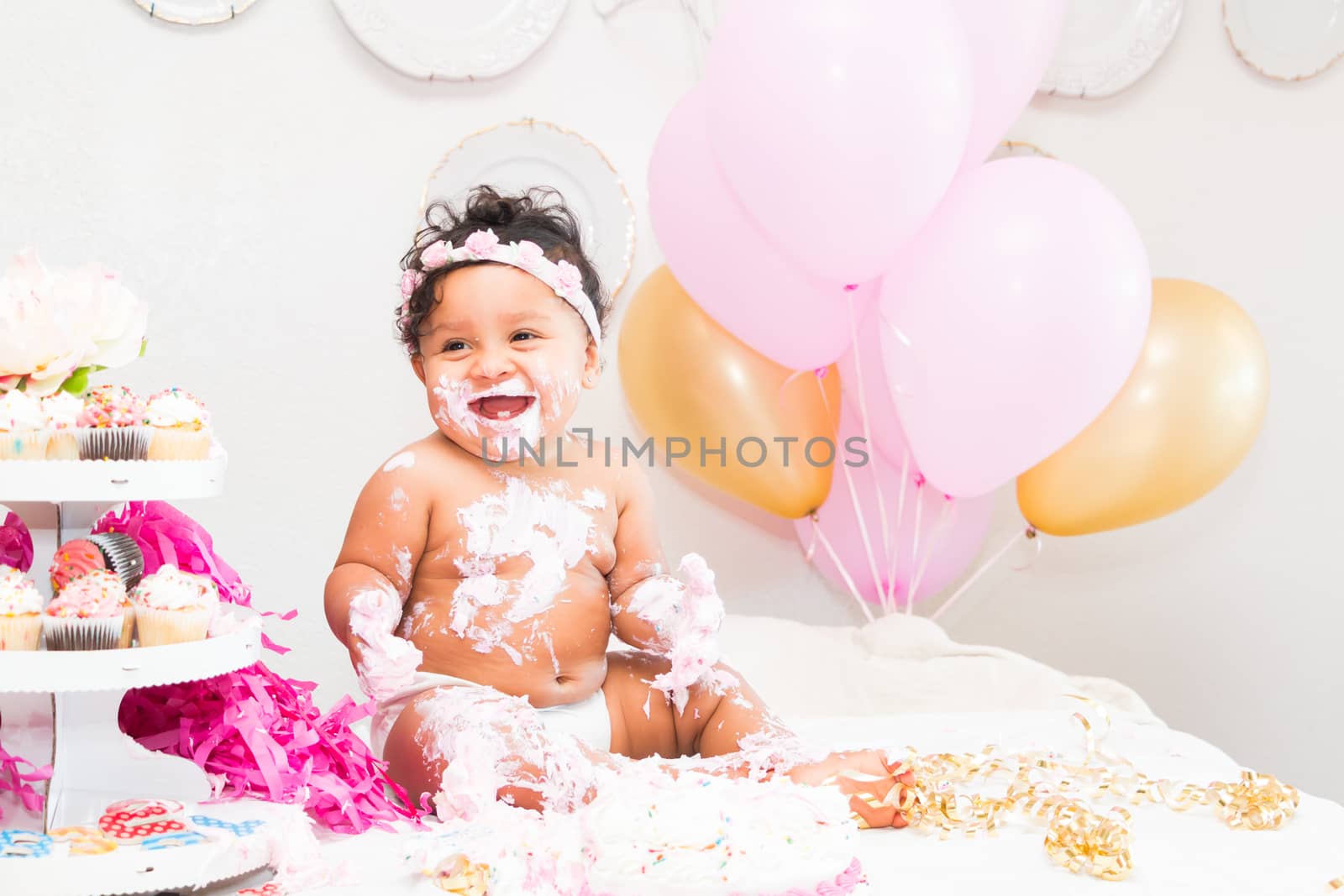 Young Baby Girl Celebrating Her First Birthday With Cake