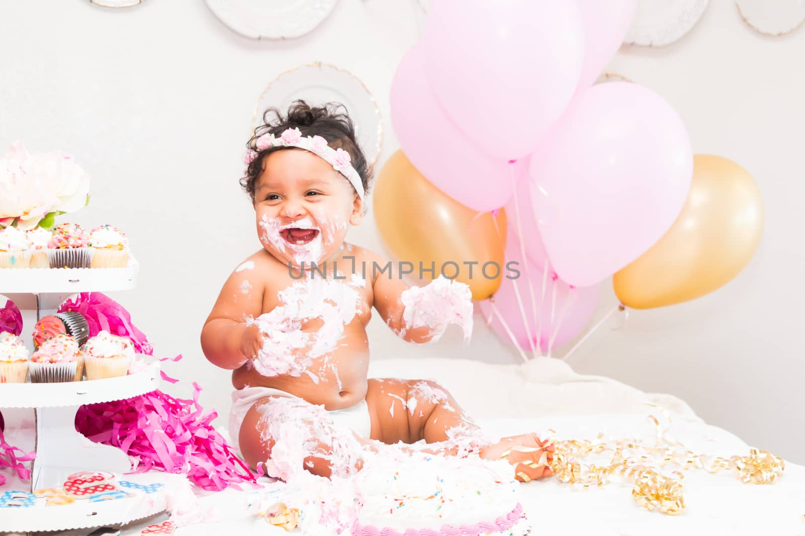 Young Baby Girl Celebrating Her First Birthday With Cake