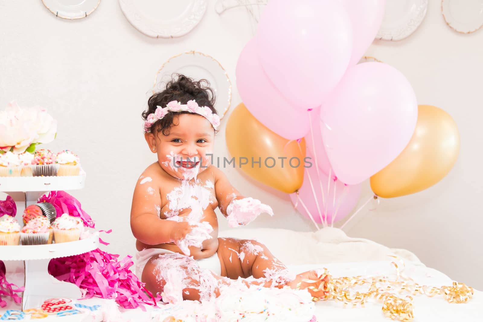 Young Baby Girl Celebrating Her First Birthday With Cake