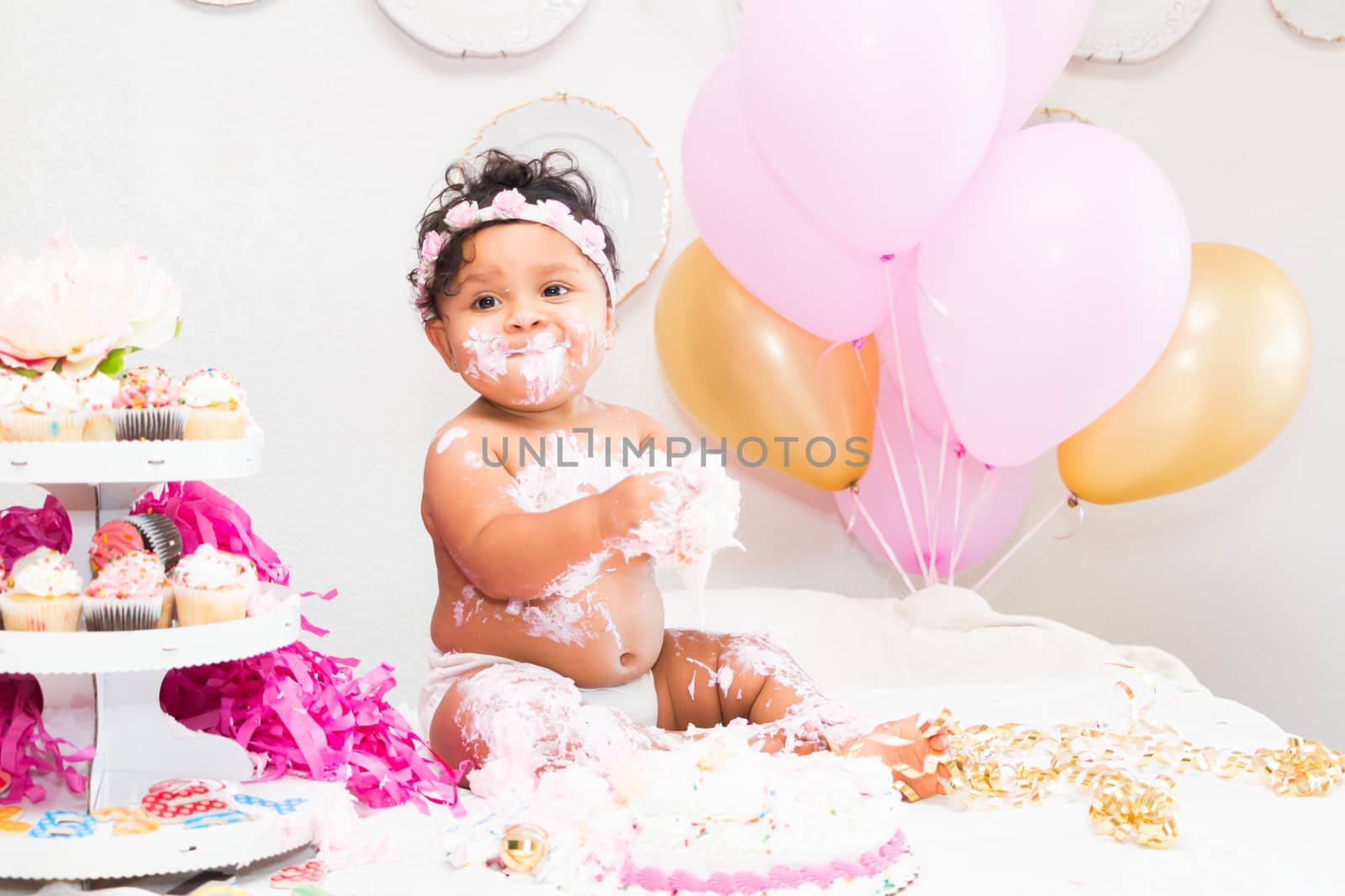 Young Baby Girl Celebrating Her First Birthday With Cake