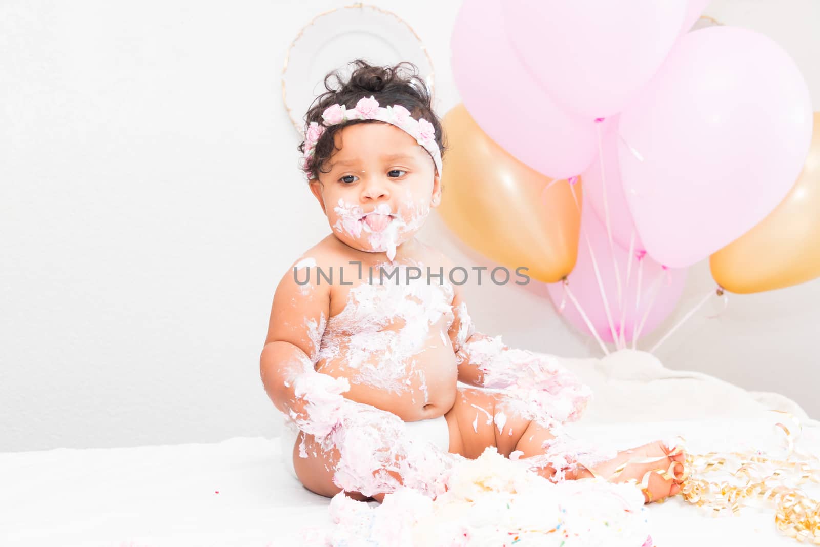 Young Baby Girl Celebrating Her First Birthday With Cake