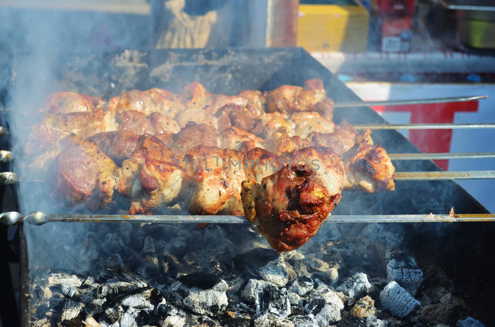 Meat is fried on skewers over charcoal on the grill