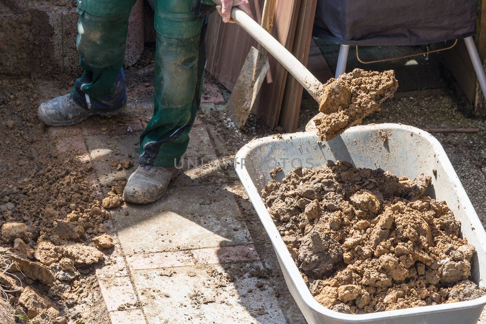 Gardening, loaded a wheelbarrow with earth excavation