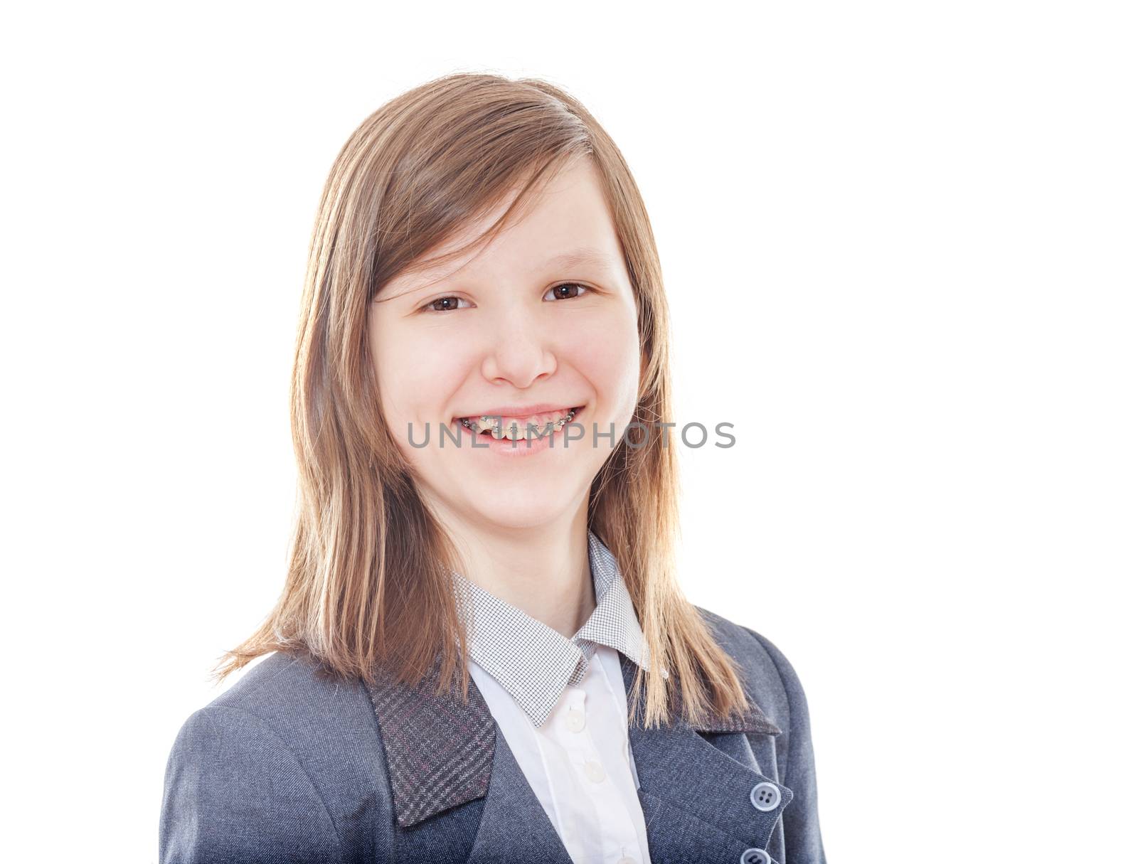 Laughing school girl wearing braces looking at camera isolated