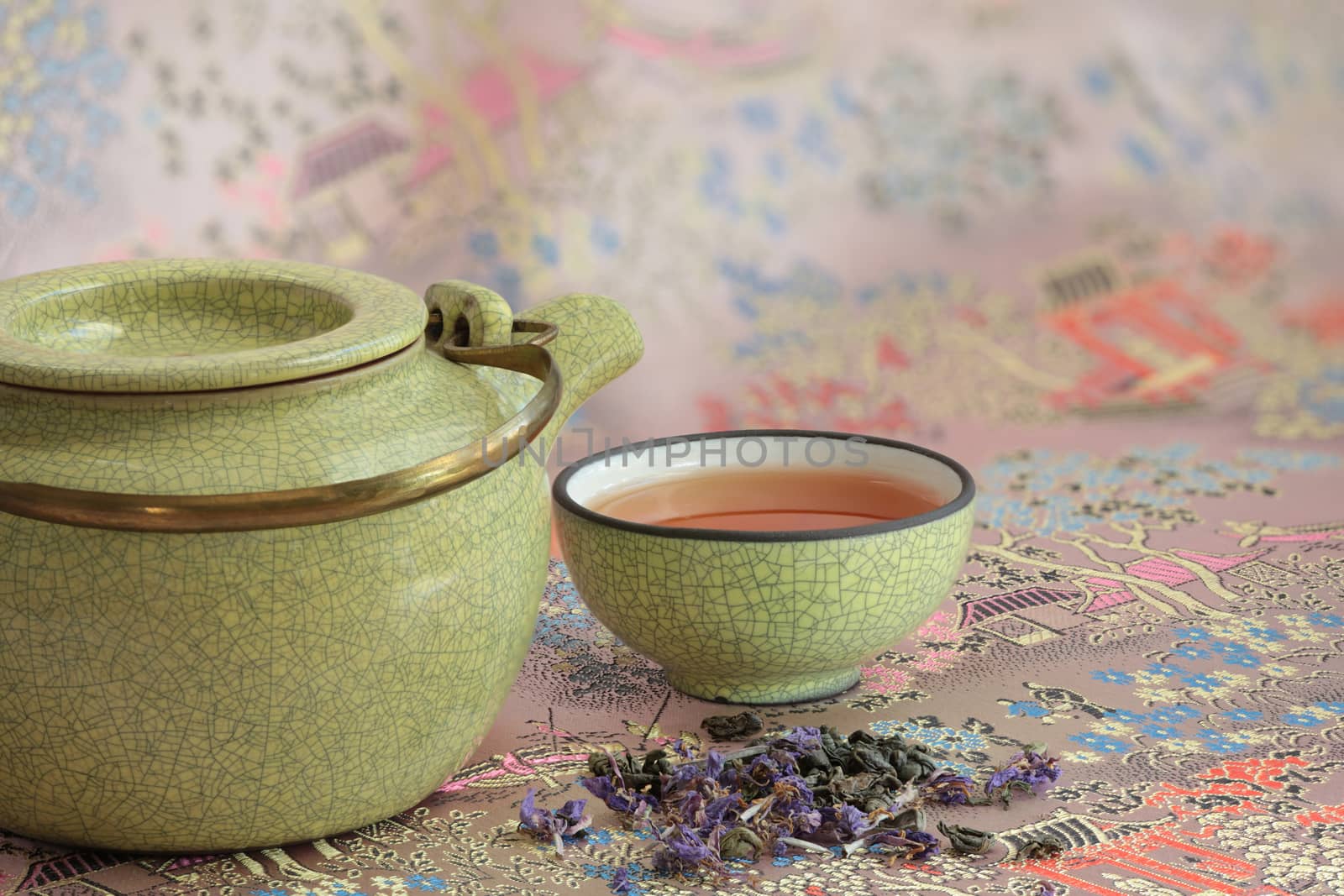 Kettle cup with tea  background of traditional eastern pattern with pagodas