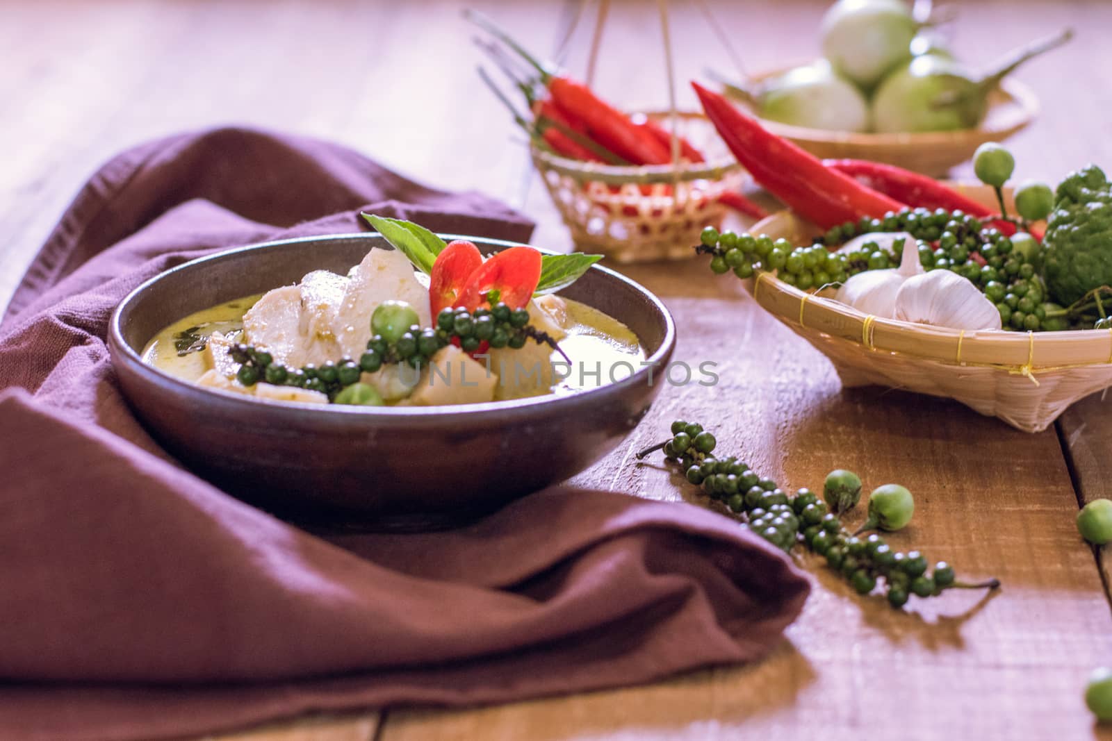 Chicken mussaman curry in bowl vegetables on wooden background by dfrsce