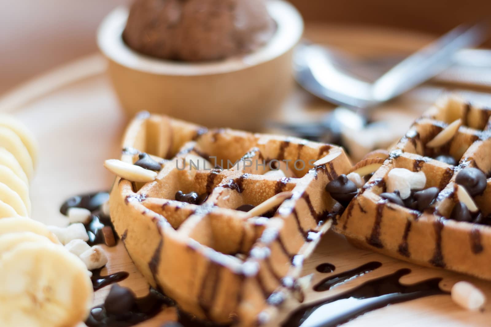 Belgian waffles with strawberry, cherry, blueberry, and chocolate sauce.