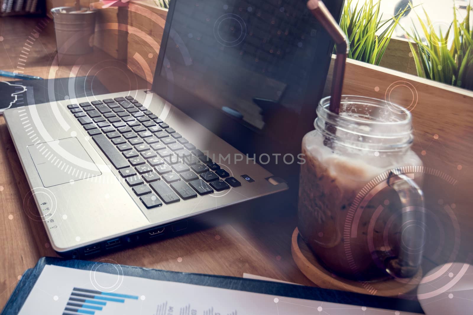 double exposure of computer on the table inside coffee shop