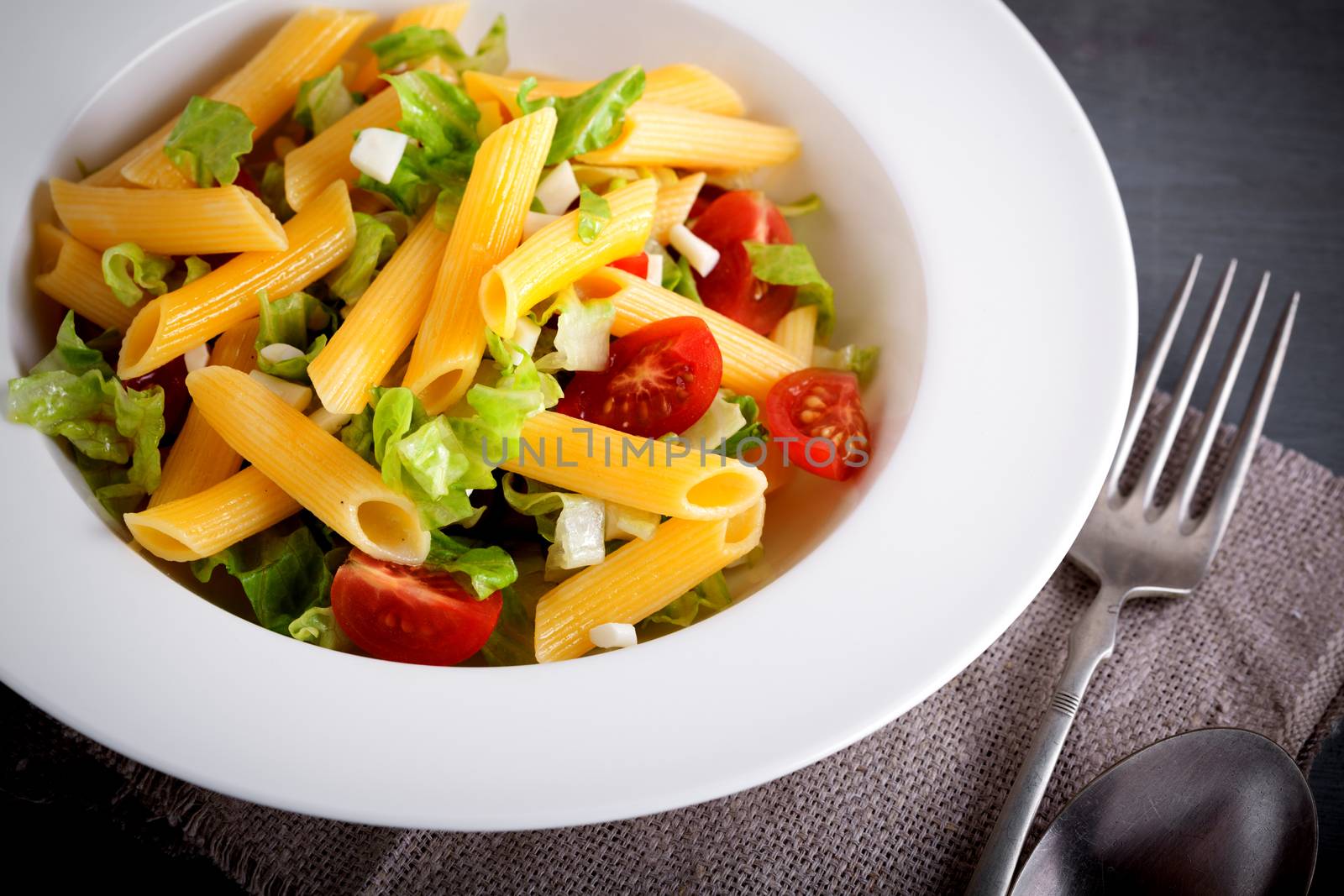 Pasta salad with fresh greenery and tomatos