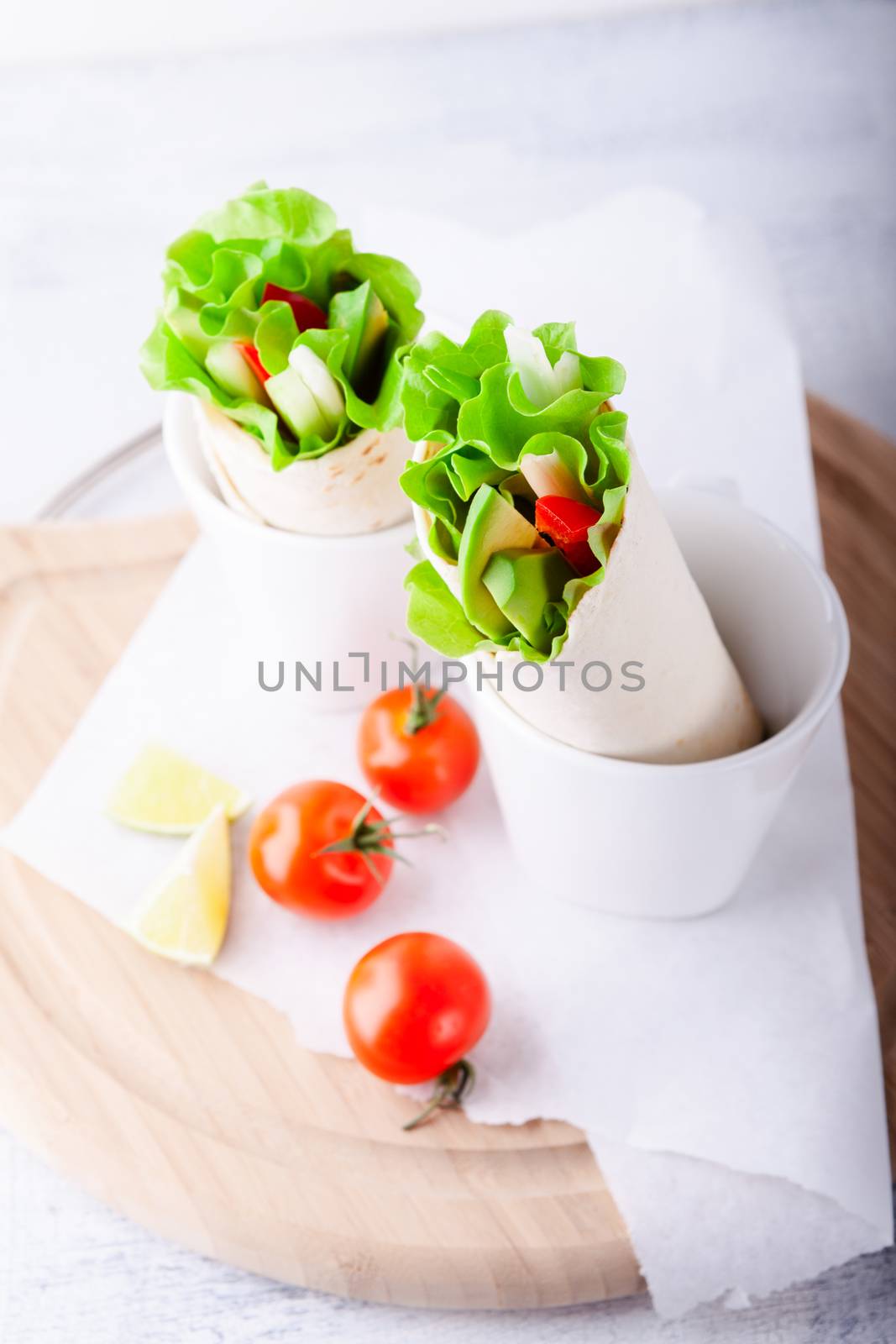 Vegetable wrap sandwiches with greenery and tomatoes