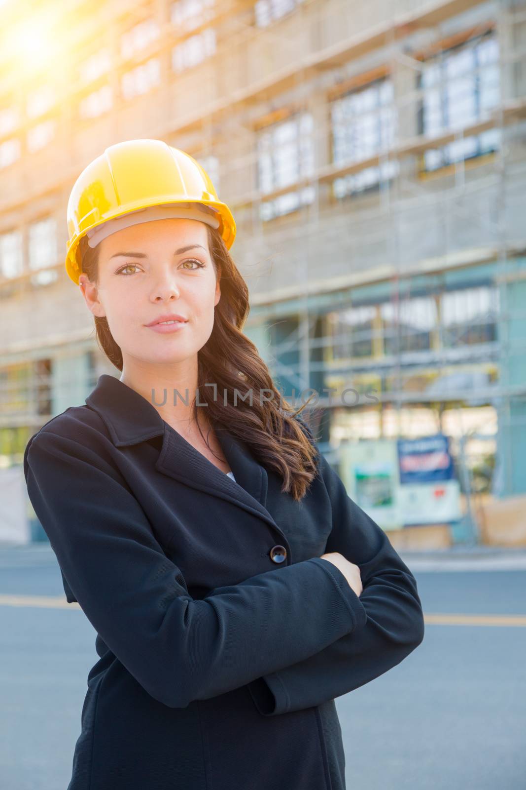 Young Attractive Professional Female Contractor Wearing Hard Hat at Construction Site. by Feverpitched