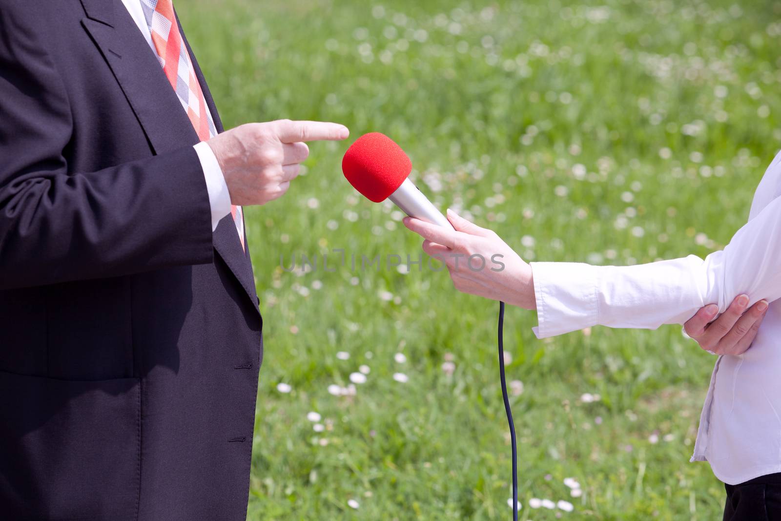 Female reporter making interview with businessperson or politician