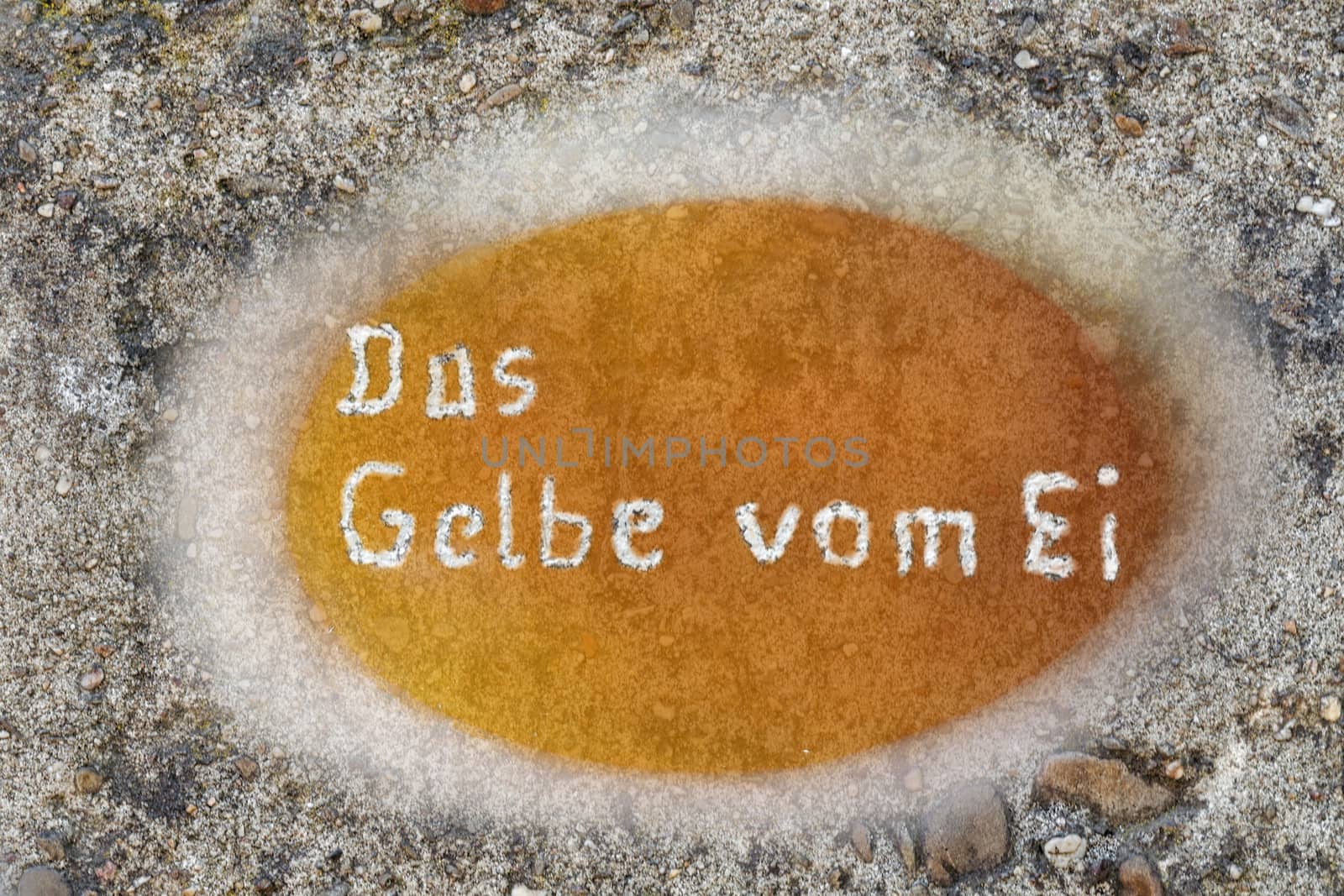 Concrete wall with inscription of the Figure of speech in German, the yellow of the egg