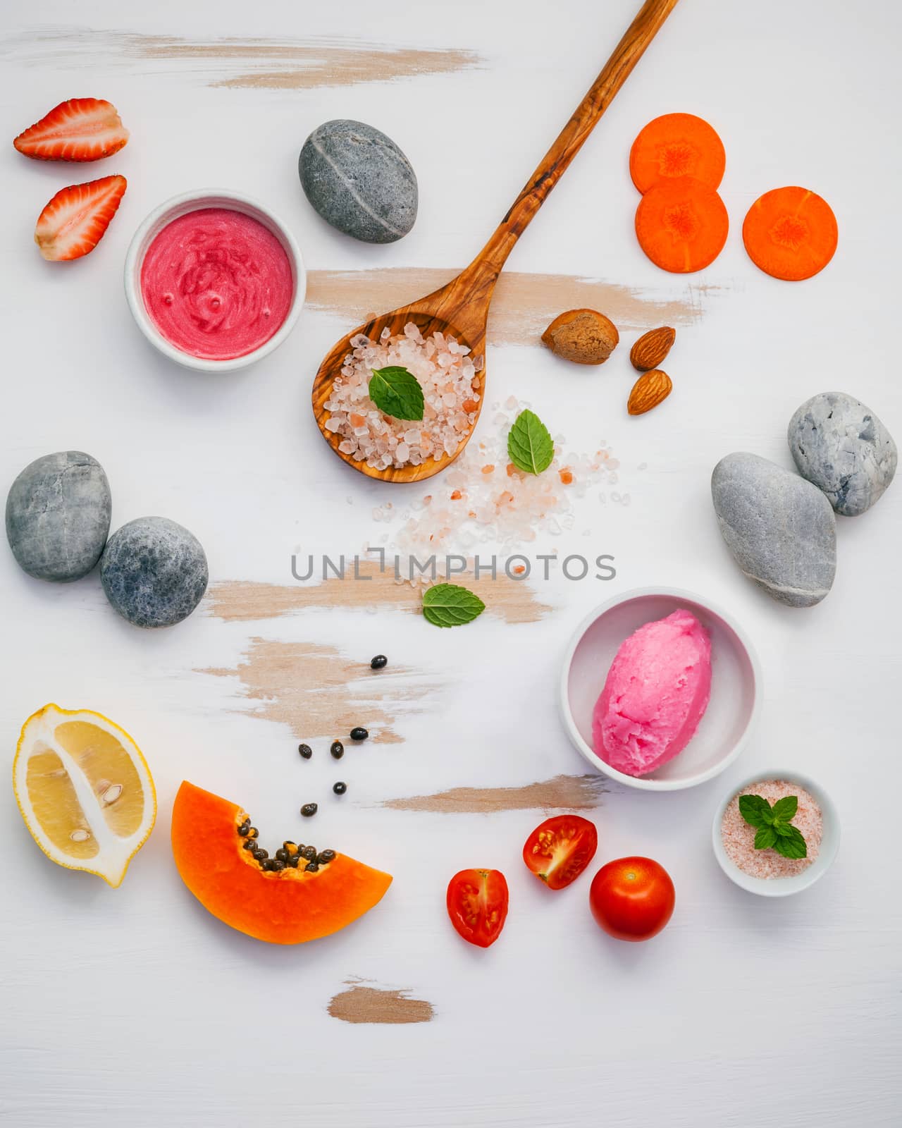 Homemade skin care and body scrubs with red natural ingredients strawberry , tomato ,himalayan salt,papaya, carrot and  stone on white wooden background with flat lay. Zen spa and oriental spa theme.