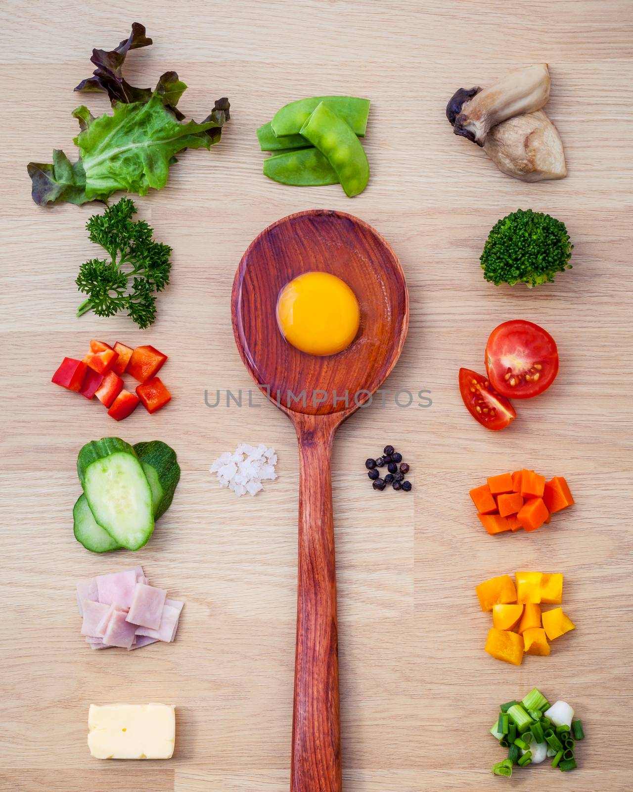 Ingredients of homemade omelet on wooden panel.Various vegetable and seasoning for cooking breakfast. Food background concept flat lay on wooden table.
