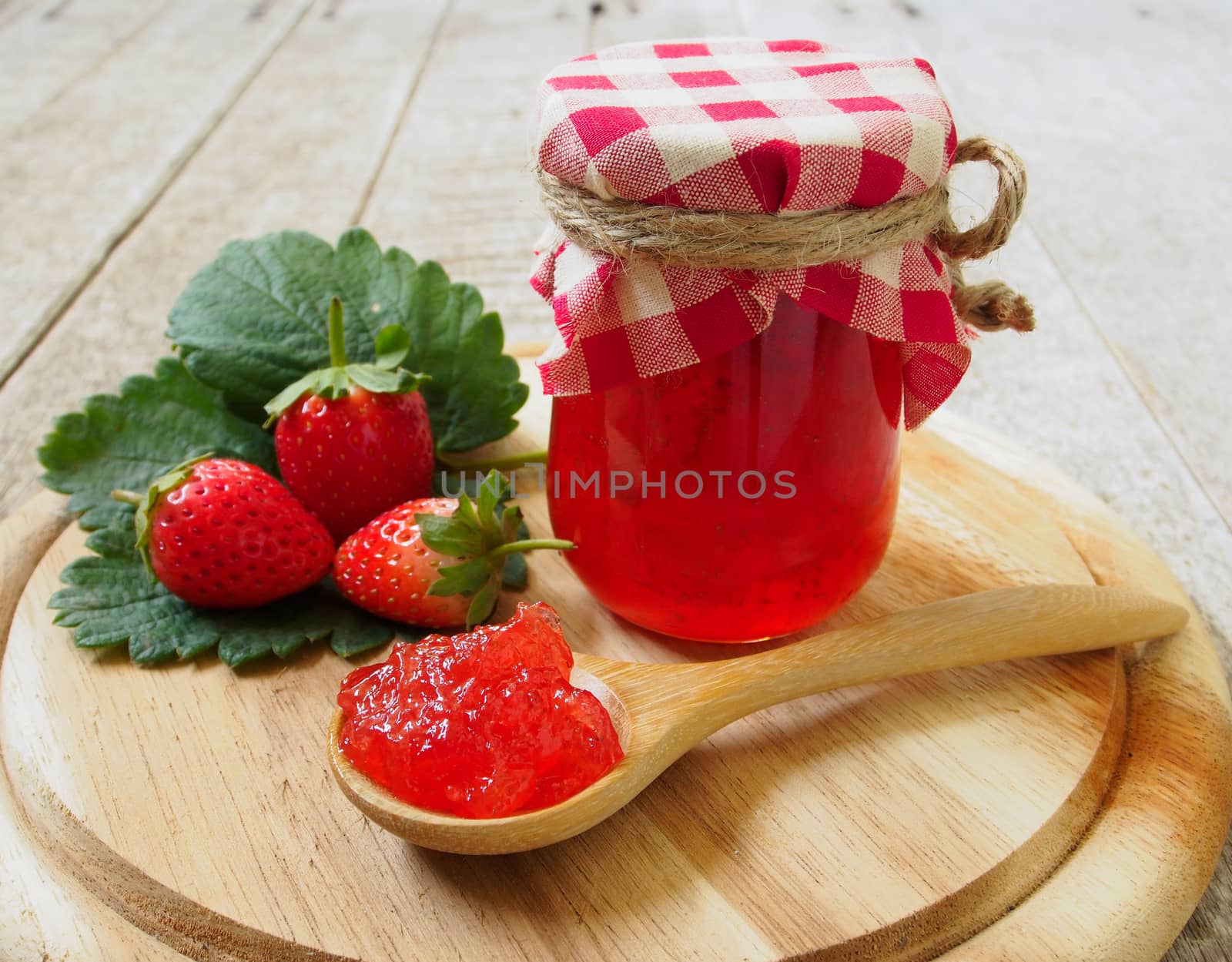 strawberry jam  in a wooden spoon