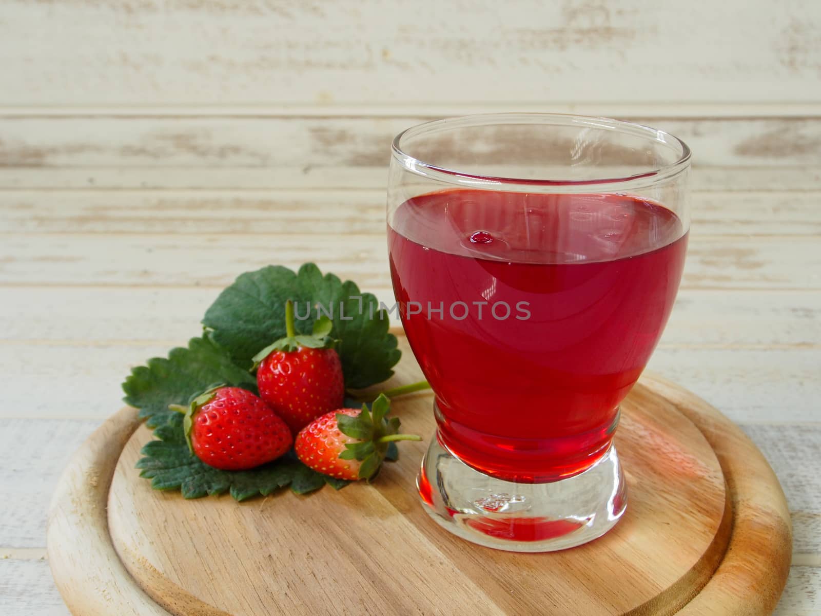 Strawberry Juice In the white wood background