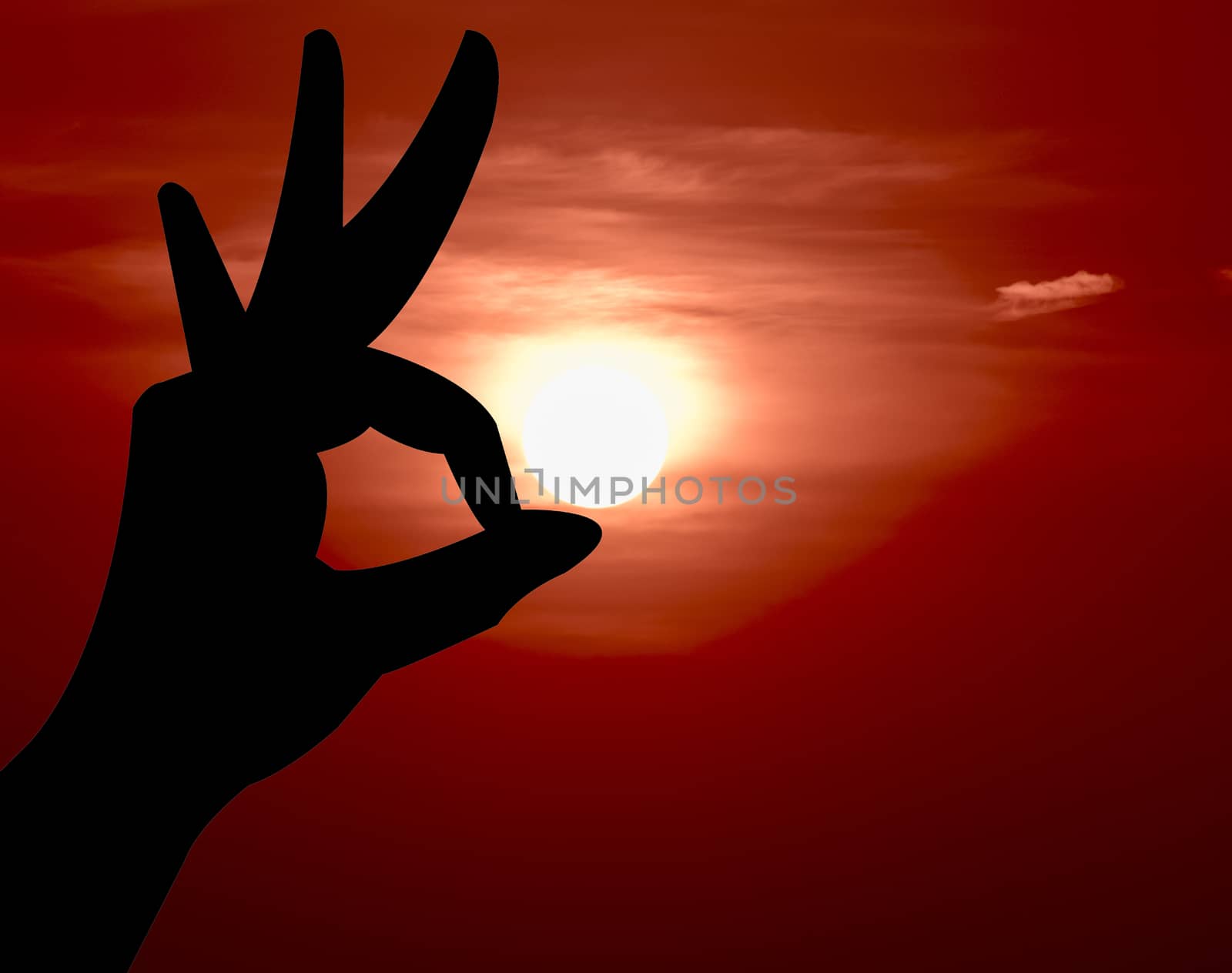 Ok hand sign silhouette. On sunset background.