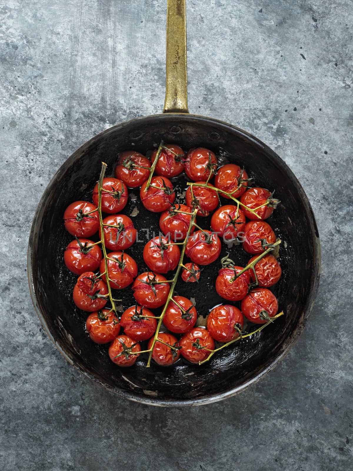 close up of rustic roasted red summer cherry tomato 