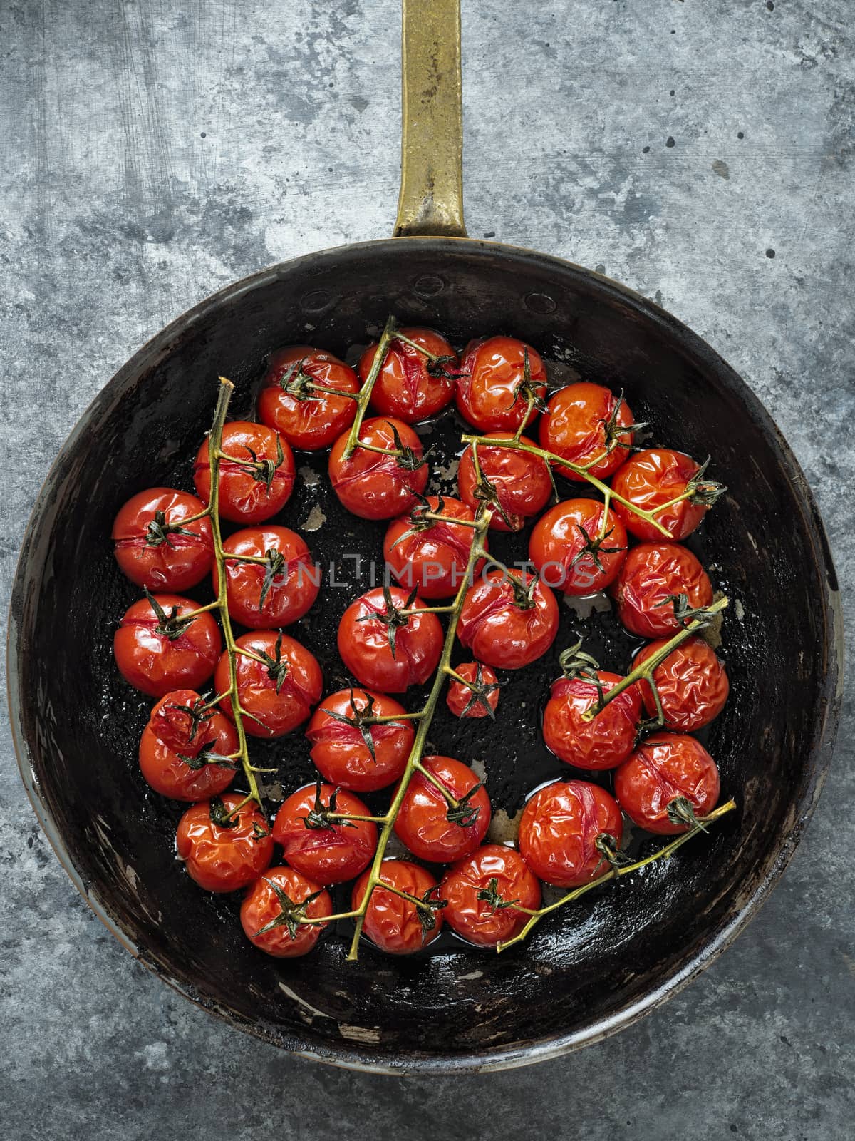 close up of rustic roasted red summer cherry tomato 