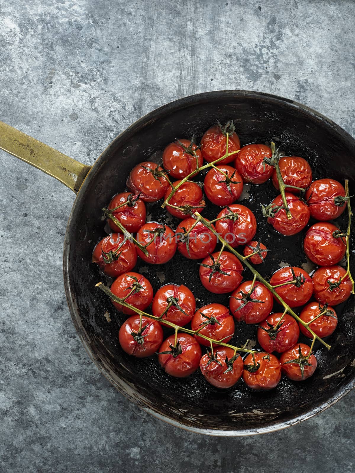 close up of rustic roasted red summer cherry tomato 