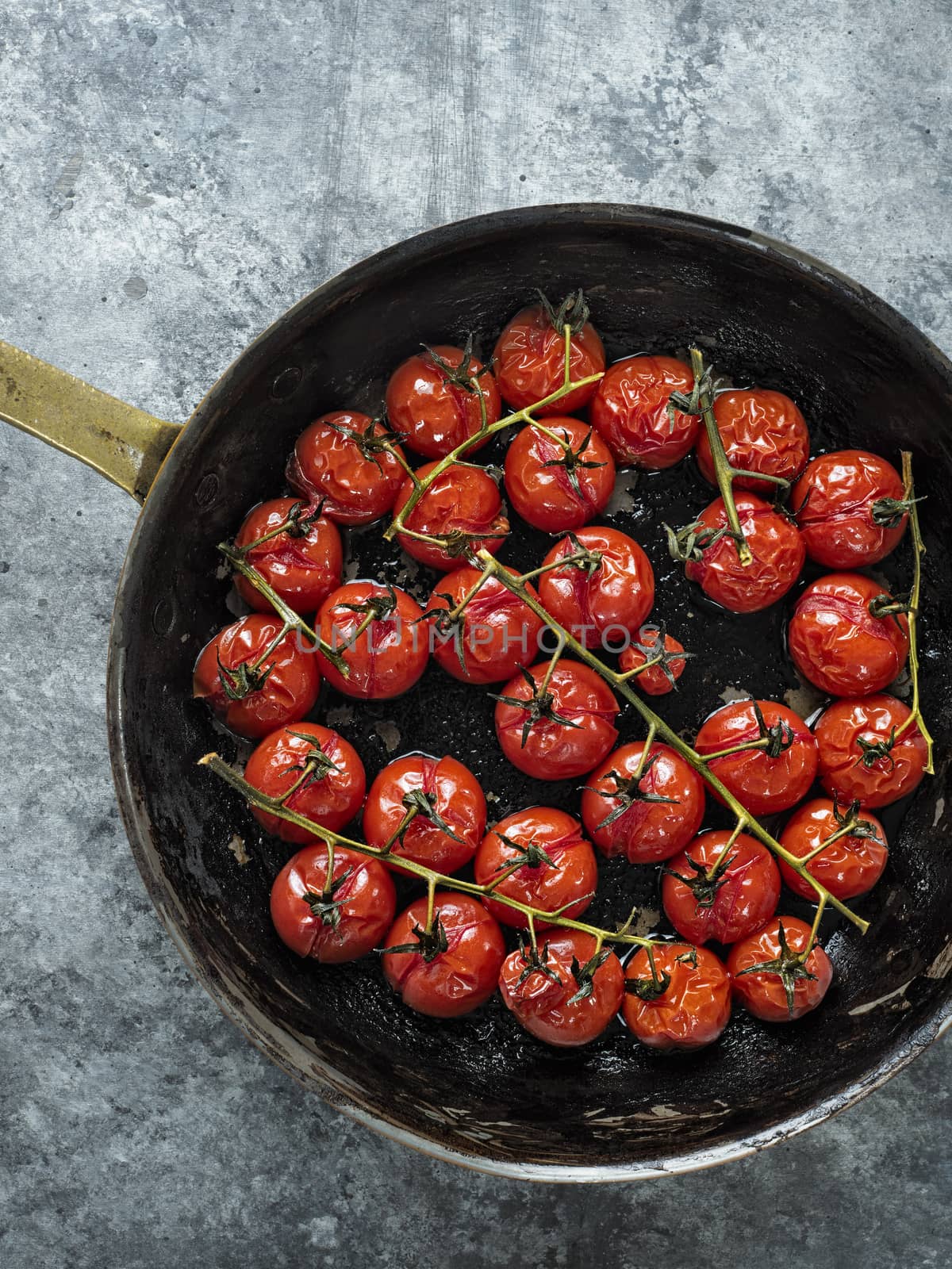 close up of rustic roasted red summer cherry tomato 