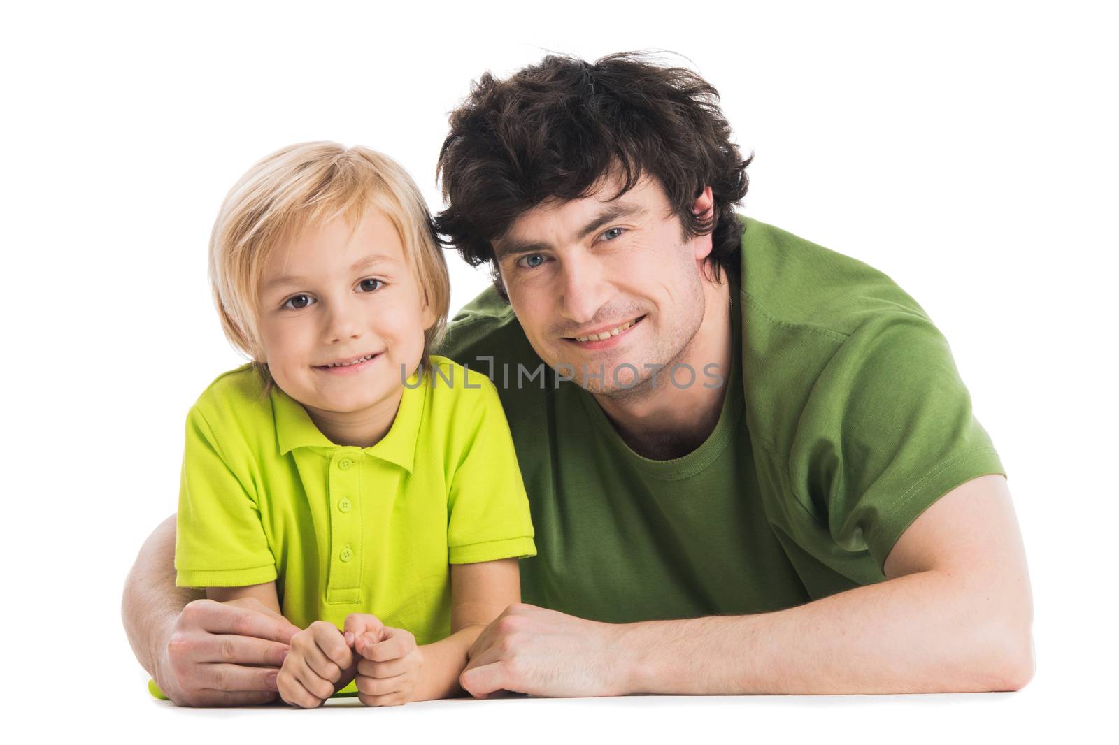 Father and son lying on the floor isolated on white background