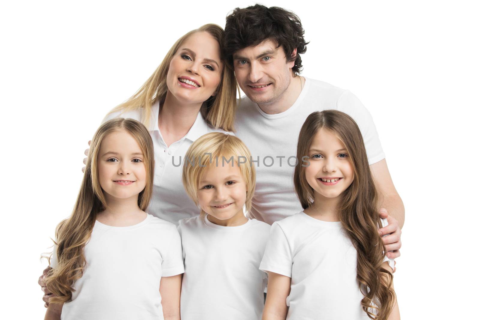 Studio portrait of family in white clothes with three children isolated on white background