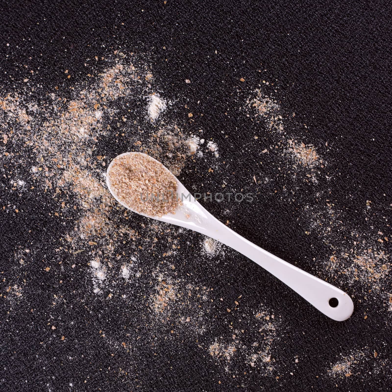 White whole-wheat flour and a spoon by victosha