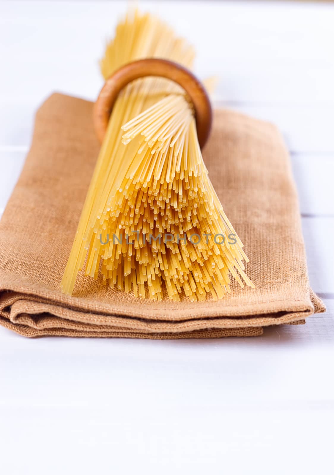 uncooked pasta on a cloth on a white background