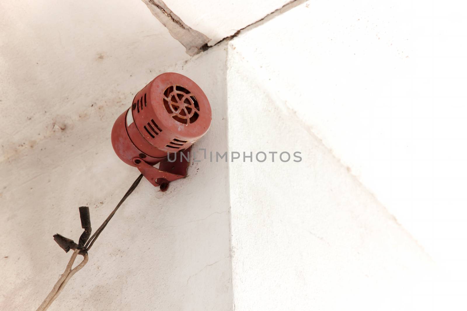 Alarm sound or siren sound. Old vintage style make a sound siren by rotating the rotor with an electric motor for security system. Ancient style installed on concrete