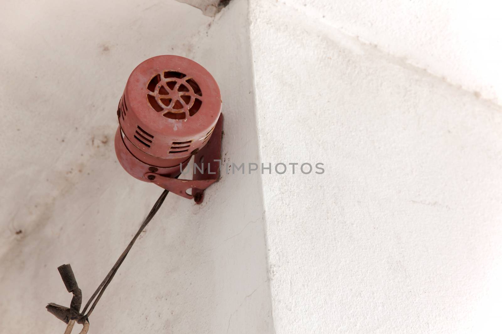 Alarm sound or siren sound. Old vintage style make a sound siren by rotating the rotor with an electric motor for security system. Ancient style installed on concrete