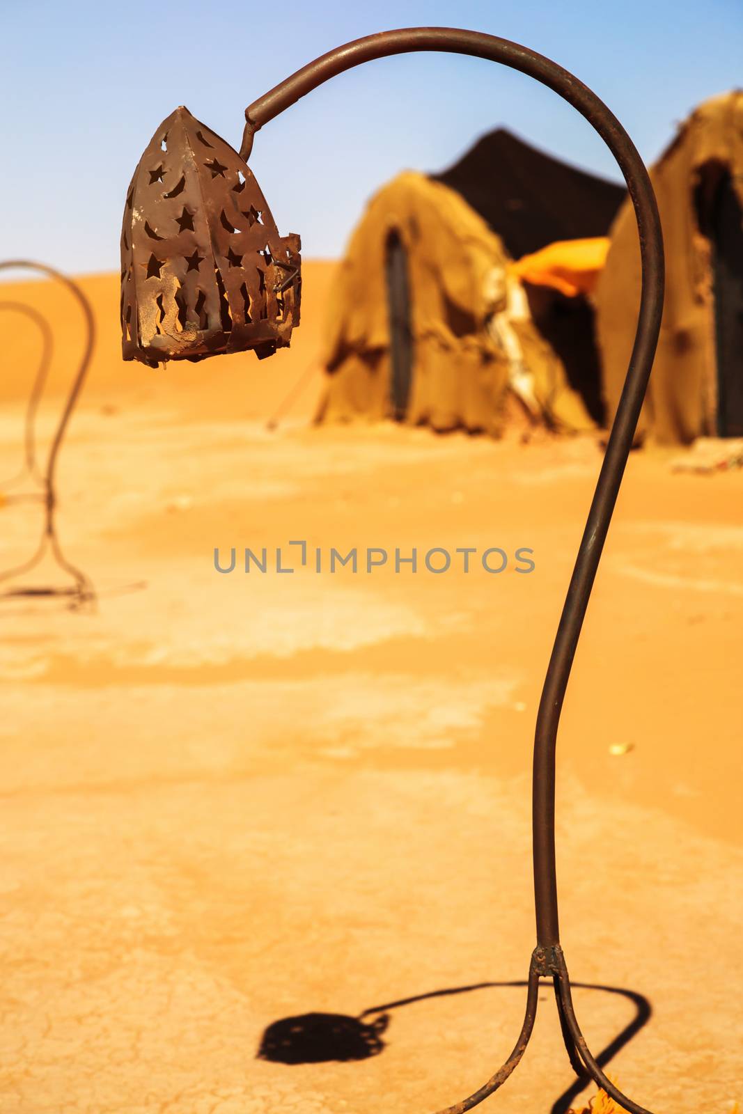 wrought iron berber lamp with traditional nomad tents on backgro by pixinoo
