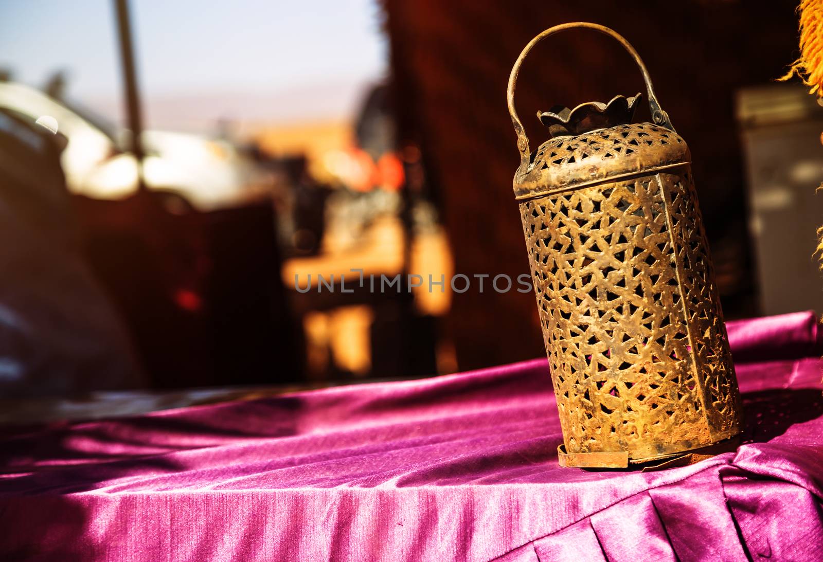 wrought iron berber lamp with traditional nomad tents on backgro by pixinoo