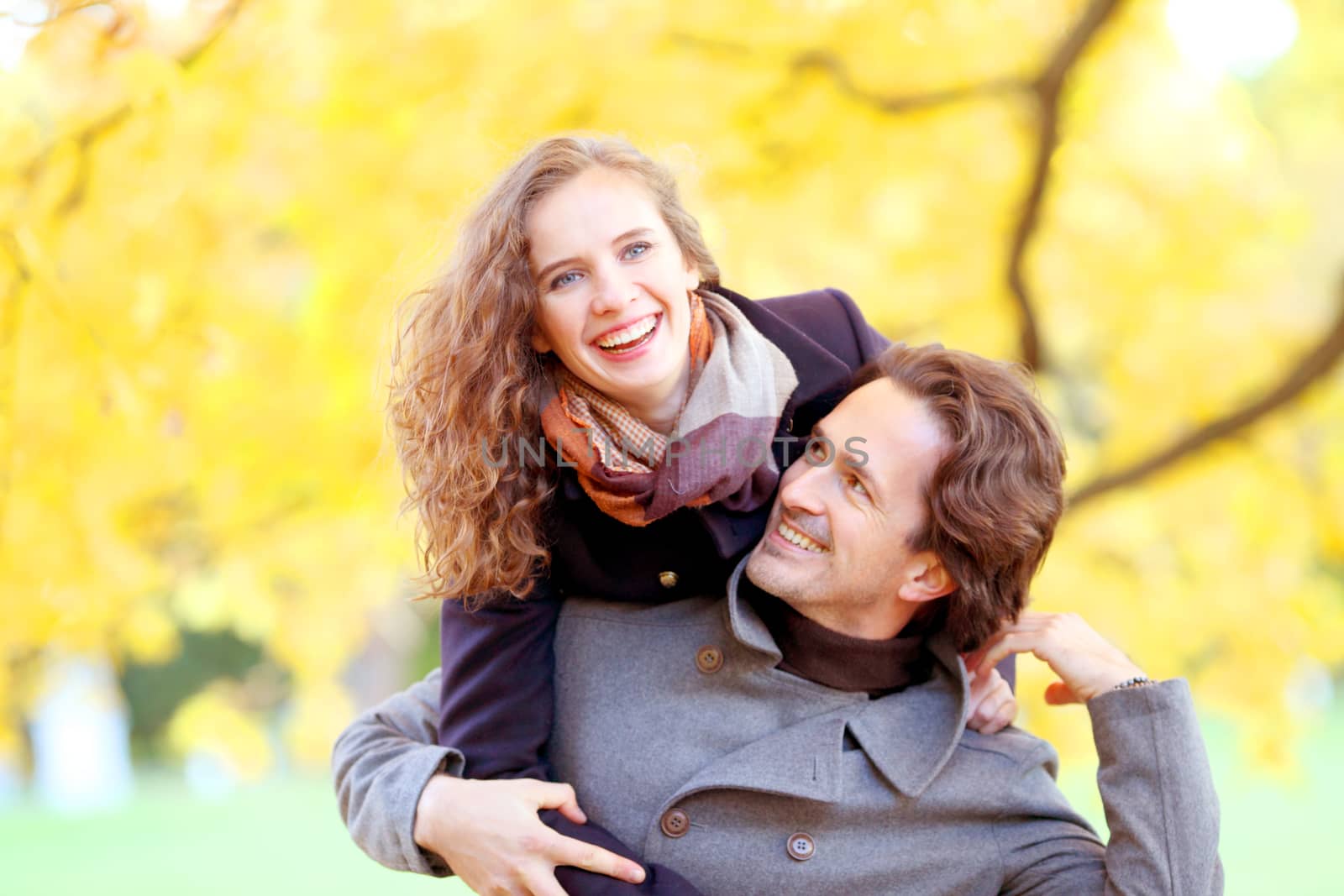 Smiling couple having fun in autumn park