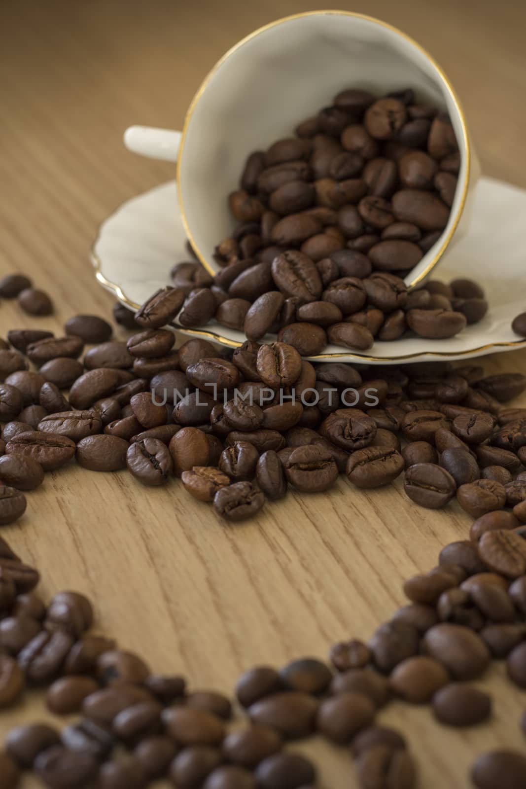 Morning heart. Heart shape made from coffee beans and a cup of coffee with beans,blurred