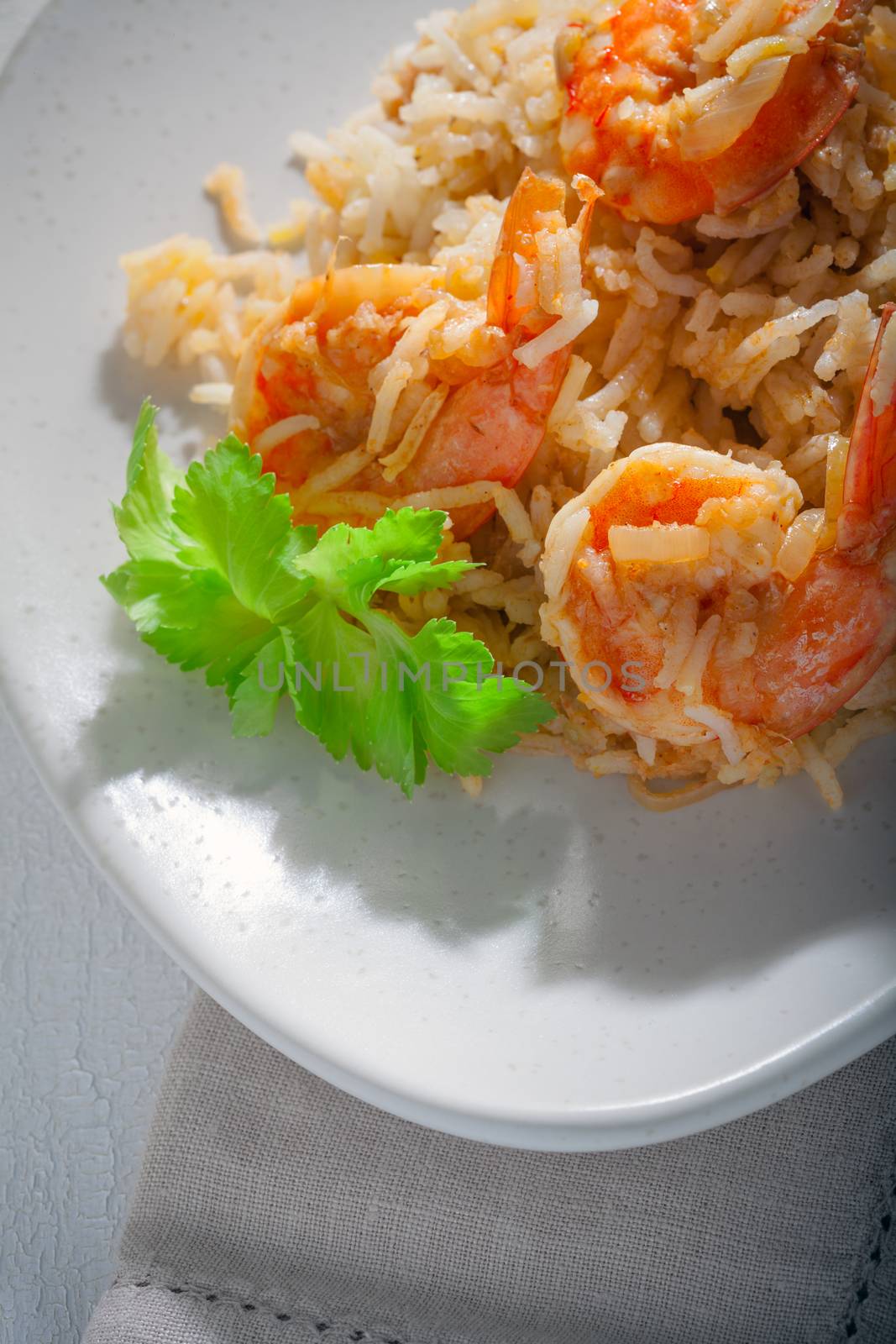 Bowl of fried rice with shrimps and greenery